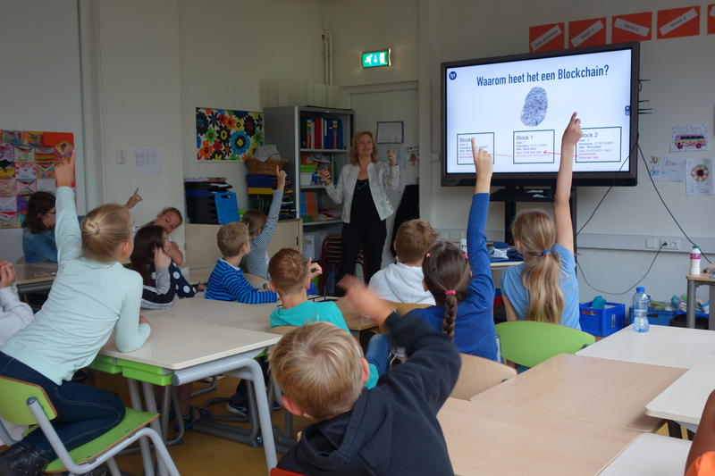 Moeder geeft les in Blockchain aan Groep 7